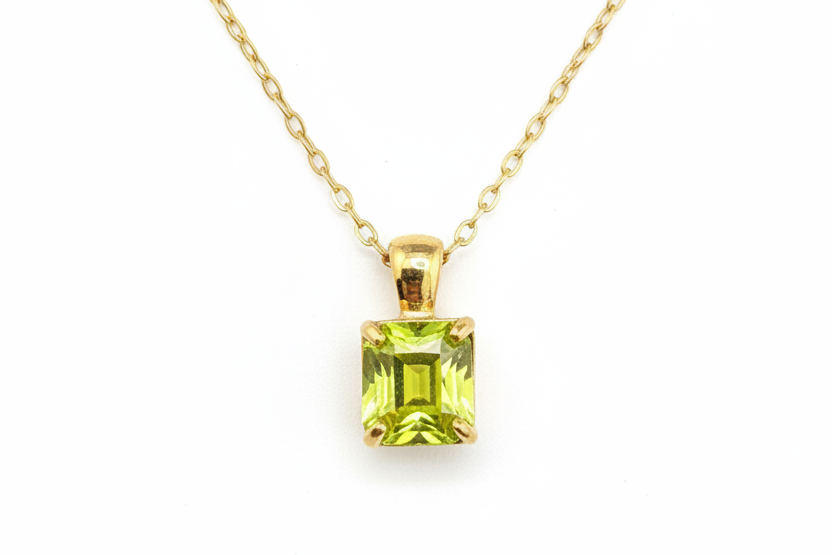 Yellow-green gemstone necklace on white background - angle 2