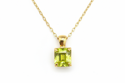 Yellow-green gemstone necklace on white background - angle 2