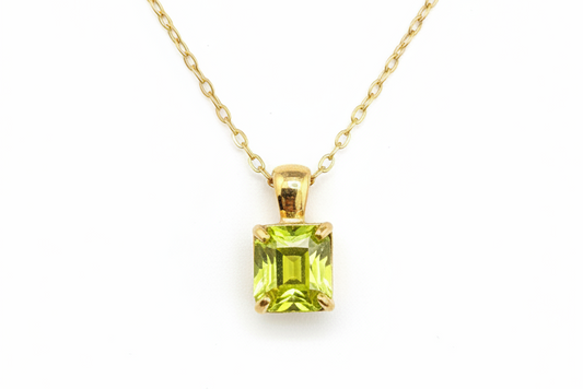 Yellow-green gemstone necklace on white background - angle 2